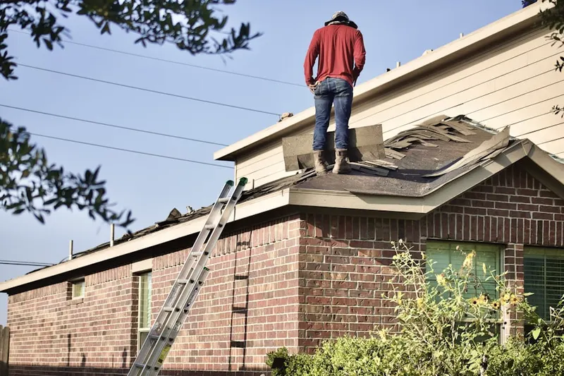 Professional roofer working on a residential roof in Menomonie